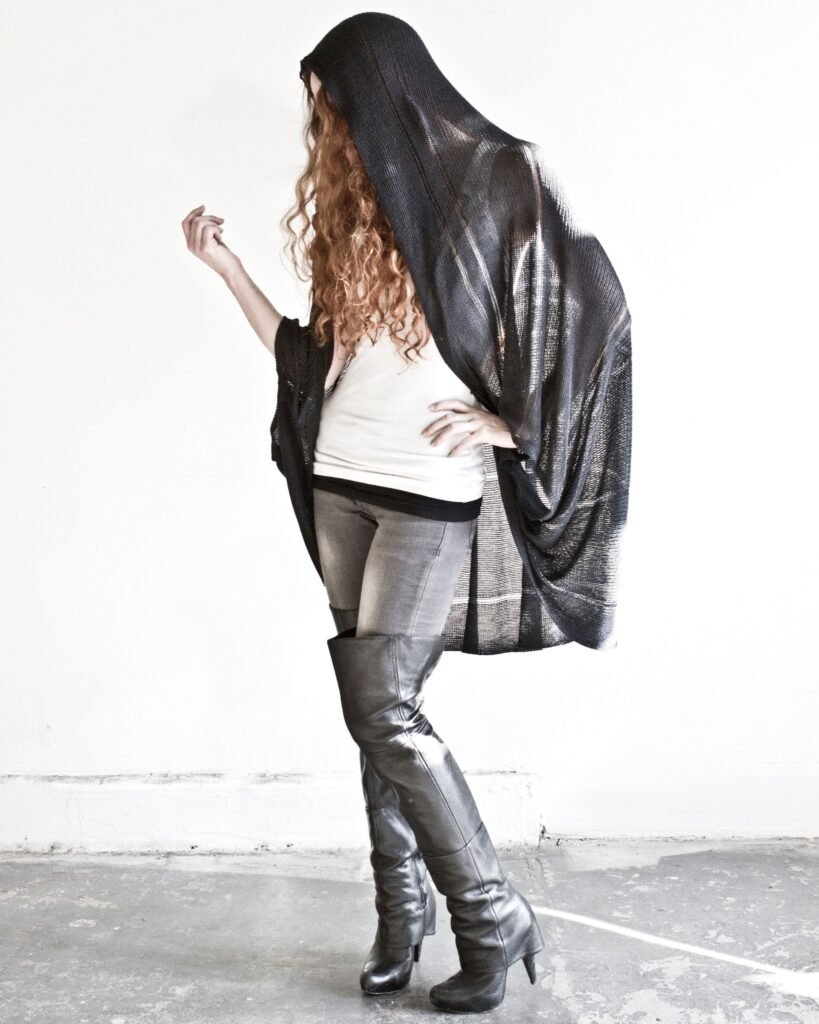 Model wearing a black knit shawl